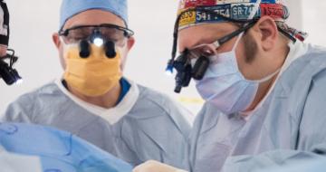 A photo of a provider and a fellow performing surgery.